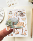 Premium Handmade Sticker Sheet
Aesthetic Cozy 105mm x 148mm - a piece on the finger and a sheet on the table with a pencil, an opened notebook