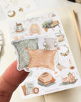 Premium Handmade Sticker Sheet
Aesthetic Cozy 105mm x 148mm - a piece on the finger and a sheet on the table with a pencil, an opened notebook