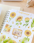 Premium Handmade Sticker Sheet Chamomile Sunflower 105mm x 148mm - a sheet on the table with an opened notebook
