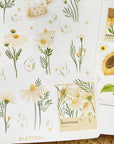 Premium Handmade Sticker Sheet Chamomile Sunflower 105mm x 148mm - a sheet on the table with an opened notebook