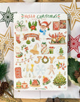 Premium Handmade Sticker Sheet Christmas 105mm x 148mm - a sheet on the table with a white flower branch, an opened notebook, 4 pinecones, a pine branch, 2 red berry branches, 4 stars