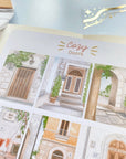 Premium Handmade Sticker Sheet Cozy Doors 105mm x 148mm - a sheet on the table