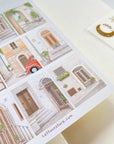 Premium Handmade Sticker Sheet Cozy Doors 105mm x 148mm - a sheet on the table