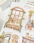 Premium Handmade Sticker Sheet Cozy Scenery 105mm x 148mm - 4 pieces on the table with dark maroon flower branch