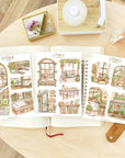 Premium Handmade Sticker Sheet Cozy Scenery 105mm x 148mm - 3 sheets on the table with the opened notebook