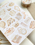 Premium Handmade Sticker Sheet Dark & Light Academia 105mm x 148mm - a washi tape and a sheet on the table with an opened notebook, a white flower branch