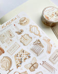 Premium Handmade Sticker Sheet Dark & Light Academia 105mm x 148mm - a washi tape and a sheet on the table with an opened notebook