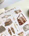 Premium Handmade Sticker Sheet Dark & Light Academia 105mm x 148mm - a washi tape and a sheet on the table with an opened notebook