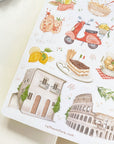 Premium Handmade Sticker Sheet In Love With Italy 105mm x 148mm - a sheet on the table with an opened notebook