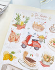 Premium Handmade Sticker Sheet In Love With Italy 105mm x 148mm - a sheet on the table with an opened notebook