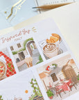 Premium Handmade Sticker Sheet Inspired by Italy 105mm x 148mm - a sheet on the table with an opened notebook