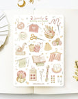 Premium Handmade Sticker Sheet Knitting Crochet 105mm x 148mm - a sheet on the table with a white flower branch, an opened notebook