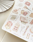 Premium Handmade Sticker Sheet Knitting Crochet 105mm x 148mm - a sheet on the table with an opened notebook