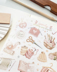 Premium Handmade Sticker Sheet Knitting Crochet 105mm x 148mm - a sheet on the table with a pencil, an opened notebook, a ruler