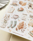 Premium Handmade Sticker Sheet Magical Cozy Fall 105mm x 148mm - a sheet on the table with an opened notebook