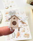 Premium Handmade Sticker Sheet Magical Cozy Fall 105mm x 148mm - a piece and a sheet on the table with a pencil, an opened notebook
