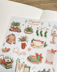 Premium Handmade Sticker Sheet Magical Cozy Winter 105mm x 148mm - a sheet on the table with an opened notebook