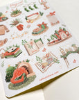 Premium Handmade Sticker Sheet Magical Cozy Winter 105mm x 148mm - a sheet on the table with an opened notebook