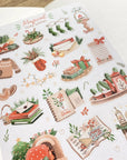 Premium Handmade Sticker Sheet Magical Cozy Winter 105mm x 148mm - a sheet on the table with an opened notebook
