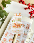 Premium Handmade Sticker Sheet Present Time 105mm x 148mm - apiece on stick and a sheet on the table with a red berry branch, a plant branch, an opened notebook