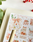 Premium Handmade Sticker Sheet Present Time 105mm x 148mm - a piece on the stick and a sheet on the table with a red berry branch, leaves, an opened notebook