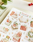 Premium Handmade Sticker Sheet
Reading in the Winter 105mm x 148mm - a sheet on the table with a branch, a red berry branch
