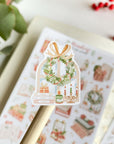 Premium Handmade Sticker Sheet
Reading in the Winter 105mm x 148mm - a piece and a sheet on the table with a branch, a red berry branch