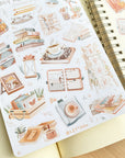 Premium Handmade Sticker Sheet Reading Time 105mm x 148mm - a sheet on the table with an opened notebook
