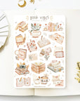 Premium Handmade Sticker Sheet Reading Time 105mm x 148mm - a sheet on the table with a white flower branch, an opened notebook
