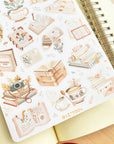 Premium Handmade Sticker Sheet Reading Time 105mm x 148mm - a sheet on the table with an opened notebook
