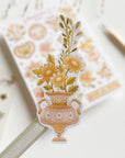 Premium Handmade Sticker Sheet Romantic Flower 105mm x 148mm - a piece and a sheet on the table with a pencil