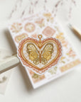 Premium Handmade Sticker Sheet Romantic Flower 105mm x 148mm - a piece and a sheet on the table with a pencil