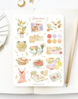 Premium Handmade Sticker Sheet Summer Breeze 105mm x 148mm - a sheet on the table with a pencil, an opened notebook