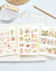 Premium Handmade Sticker Sheet Summer Breeze 105mm x 148mm - 3 sheets on the table with a pencil, an opened notebook, a chapter heading