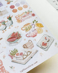 Premium Handmade Sticker Sheet Summer Breeze 105mm x 148mm - a sheet on the table with an opened notebook
