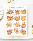 Premium Handmade Sticker Sheet Sweet Pumpkin 105mm x 148mm - a sheet on the table with a white flower branch, an opened notebook