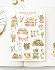 Premium Handmade Sticker Sheet
Veggie Garden 105mm x 148mm - a sheet on the table with a white flower branch, an opened notebook