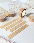 Premium Handmade Washi Tape Brown Grid 15mm x 10m - 4 pieces and 4 washi tapes on the table with 2 dark maroon flower branches, a chapter heading, a sticker sheet