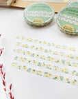 Premium Handmade Washi Tape Chamomile 5mm x 10m - 5 pieces and 3 washi tapes on the table with a dark maroon flower branch, a notebook