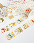 Premium Handmade Washi Tape Dreamy Stamp 25mm x 5m - 2 pieces and 3 washi tapes on the table with a pink flower branch, a heading chapter, a notebook, a sticker sheet