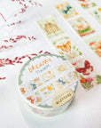 Premium Handmade Washi Tape Dreamy Stamp 25mm x 5m - 3 pieces and a washi tape on the table with a pink flower branch, a notebook
