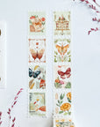 Premium Handmade Washi Tape Dreamy Stamp 25mm x 5m - 2 pieces on the table with 2 pink flower branches, a sticker sheet