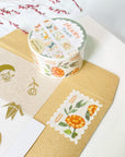 Premium Handmade Washi Tape Dreamy Stamp 25mm x 5m - a piece and a washi tape on the table with a pink flower branch, an envelope, a sticker sheet