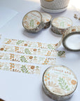 Premium Handmade Washi Tape Flower Grid 15mm x 10m - 4 pieces and 5 washi tapes on the table with 2 white flower branches, a cup of tea
