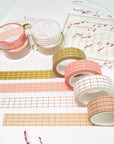 Premium Handmade Washi Tape
Gridtastic 15mm x 10m - 4 pieces and 8 washi tapes on the table with a dark maroon flower branch, a chapter heading, a sticker sheet