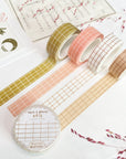 Premium Handmade Washi Tape
Gridtastic 15mm x 10m - 4 pieces and 5 washi tapes on the table with 2 dark maroon flower branches, a chapter heading, a sticker sheet