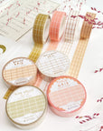 Premium Handmade Washi Tape
Gridtastic 15mm x 10m - 4 pieces and 8 washi tapes on the table with 2 dark maroon flower branches, a chapter heading, a sticker sheet