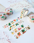 Premium Handmade Washi Tape Happy Holidays 20mm x 10m - 4 pieces and 4 washi tapes on the table with 2 dark maroon flower branches, a sticker sheet, a chapter heading, a notebook