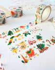 Premium Handmade Washi Tape Happy Holidays 20mm x 10m - 4 pieces and 4 washi tapes on the table with 2 dark maroon flower branches, a sticker sheet, a chapter heading, a notebook