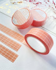 Premium Handmade Washi Tape Peach Grid 15mm x 10m - 3 pieces and 3 washi tapes on the table with
a dark pink flower branch, a chapter heading, a sticker sheet